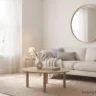 Bright and airy living room with a neutral cream sofa, round oak coffee table, sheer linen curtains, and a round wall mirror.